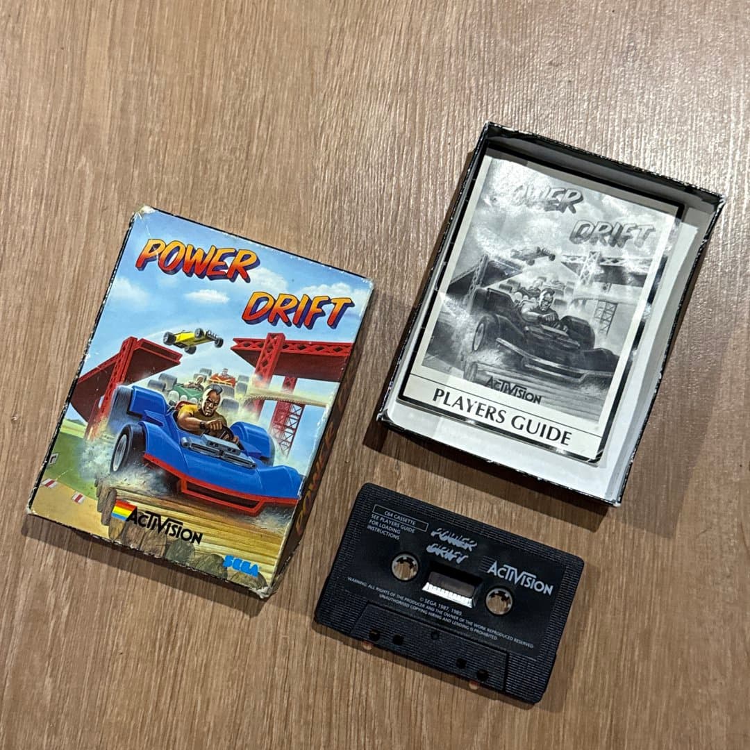 A vintage Power Drift racing game for Commodore 64, including cassette, box, and player's guide. on Save All