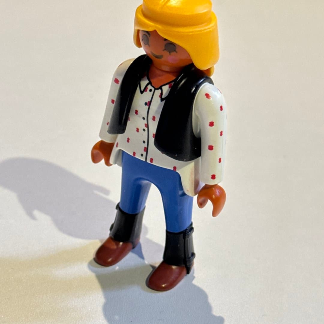 Playmobil Geobra character with yellow hair, white polka dot shirt, black vest, and blue pants. on Save All